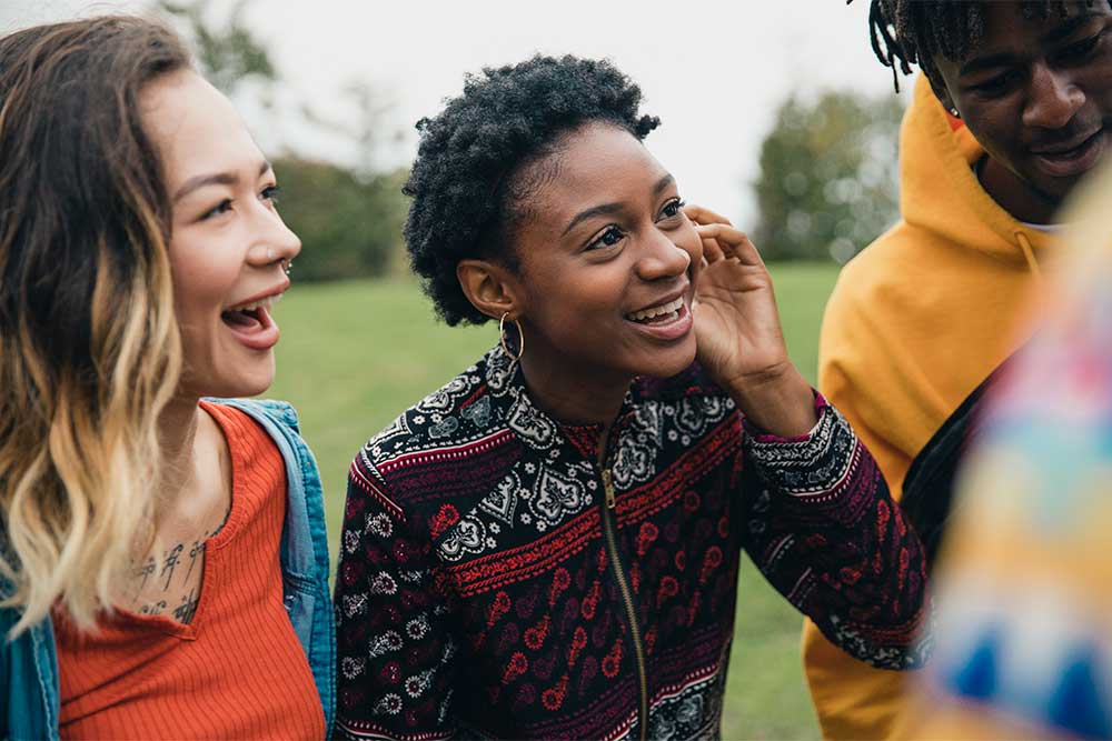 Stock image of diverse teens outside laughing