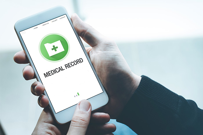 Hand holds smartphone with medical record on screen