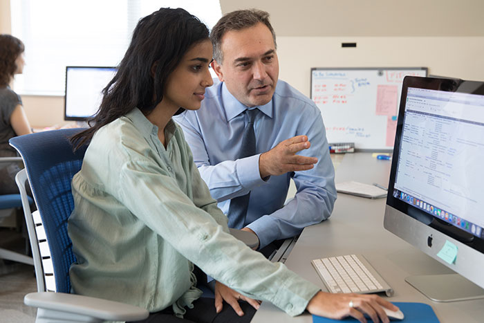 Psychiatrist works with lab assistant reviewing data
