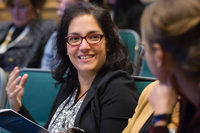 Dr. Laura Germine talks to another guest at a conference