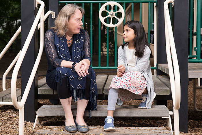 Clinician talks with young girl