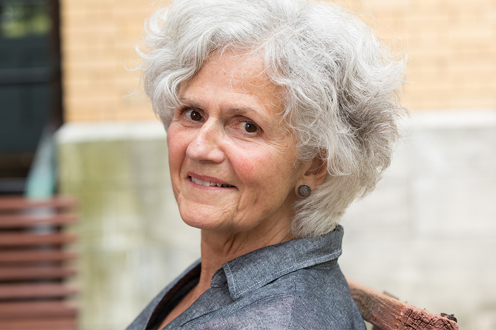 Older woman sits outside