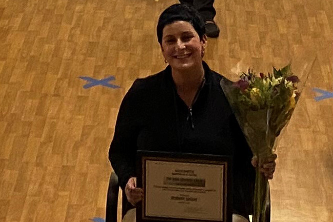 Woman accepts certificate