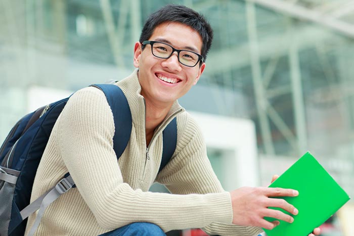 College student with book and backpack