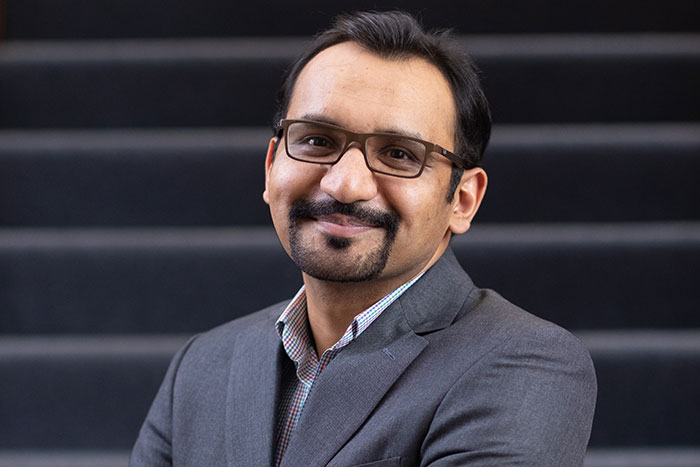 Dr. Alaptagin Khan sits on stairs