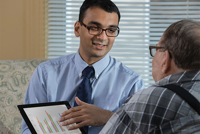 Dr. Ipsit Vahia shows patient data on a tablet
