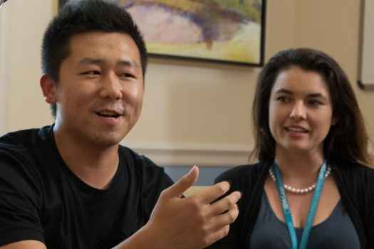 Young man talks with clinicians