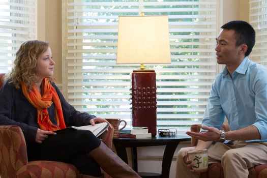 Patient and clinician talk in living room