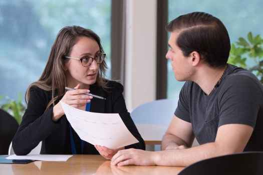 Staff talks to patient at table