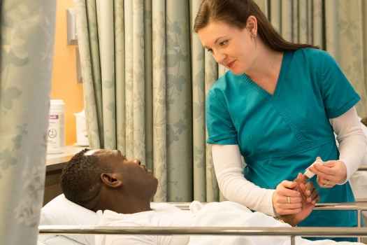 ECT nurse talks to patient in recovery room