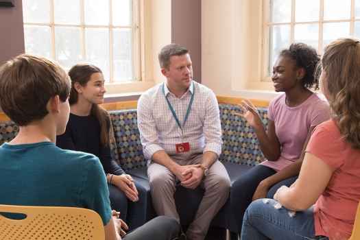 Teens in group therapy with clinician