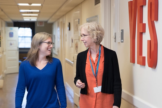 Two women walking in hallway
