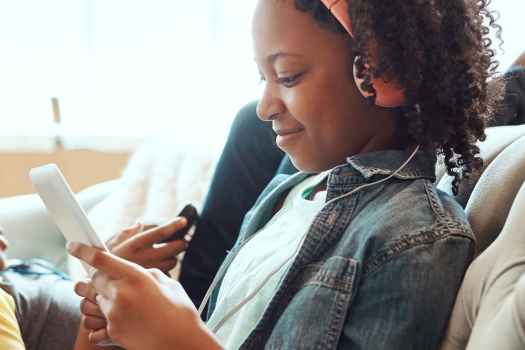 woman and child listen to music on headphones