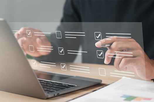 Hands with laptop and overlay graphic of checkboxes and lines as if text