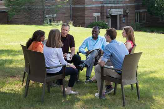 Group of people sitting and smiling outside