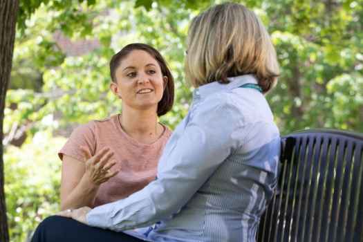 Patient speaking with a therapist on a park bench