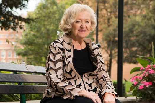 Woman sits on bench outside