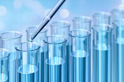 Blue liquid in test tubes with a pipette droplet