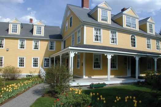 Yellow inn with tulips in front