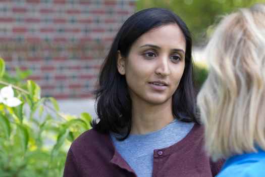 Two women talk outside