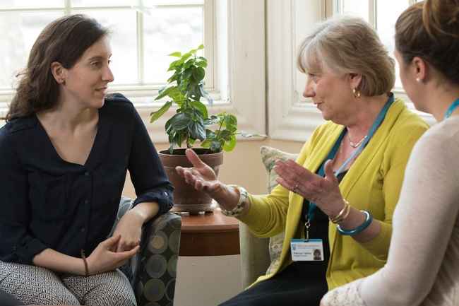 Clinicians talk to patient