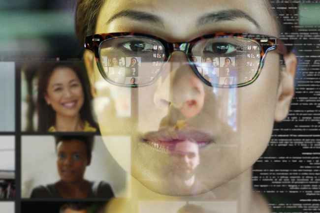 Woman looks at screens