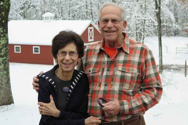 Older couple poses outside in snowy landscape