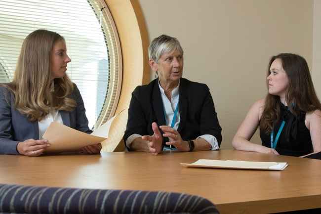 McLean staff talks at table