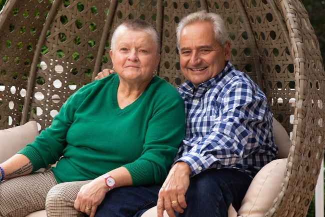Two people sit in outdoor seating