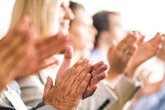Row of people clapping