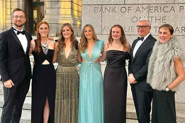 Pierce family in fancy dress poses outside museum
