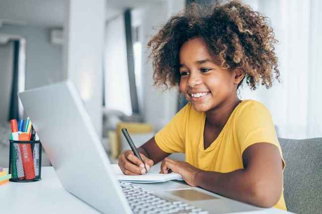 Girl smiling with on computer