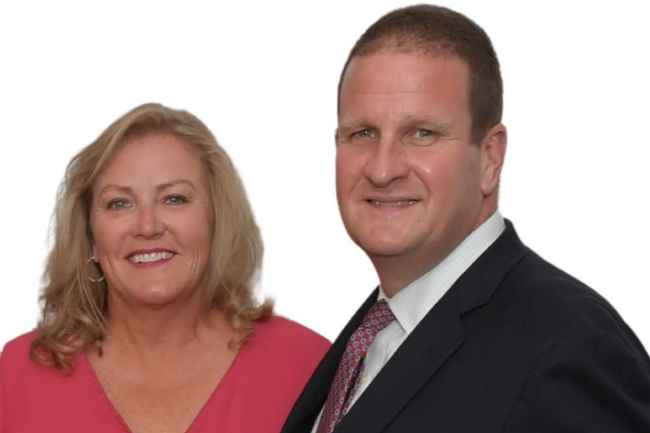 Two people smiling while posing for photo