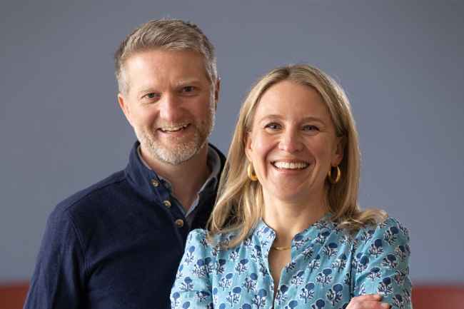 Couple posed for camera, blue gray background