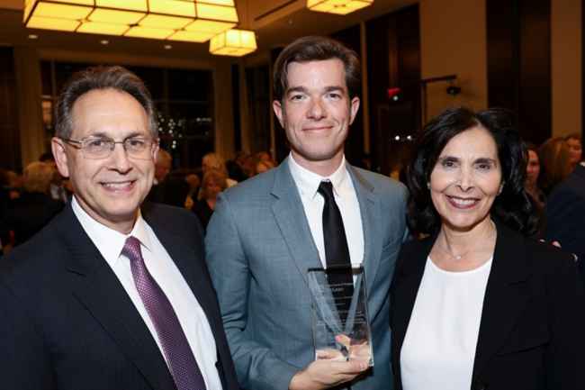 Group smiling with award