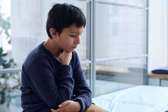 Boy sits in medical examination room