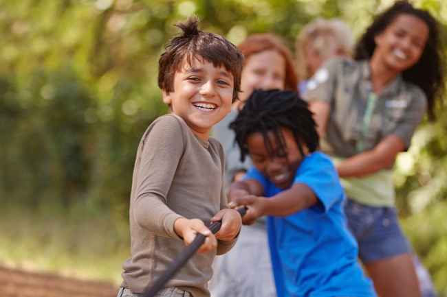 Children tugging on a rope and laughing