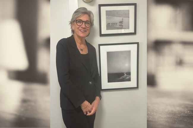 Woman smiling with framed art