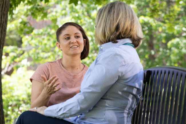Patient speaking with a therapist on a park bench