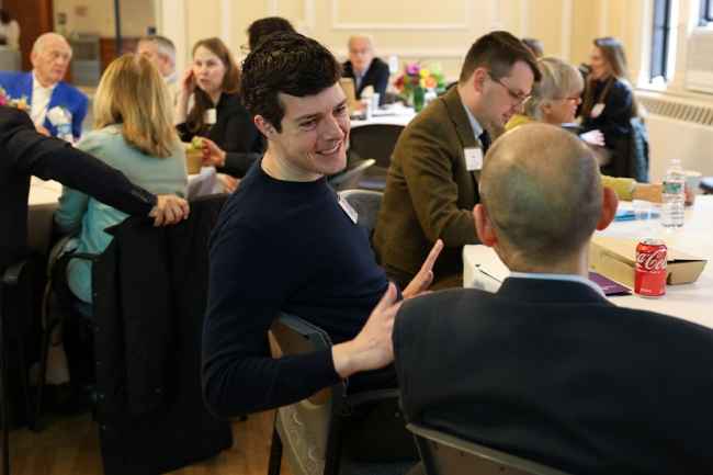 Group of people sitting at a table talking