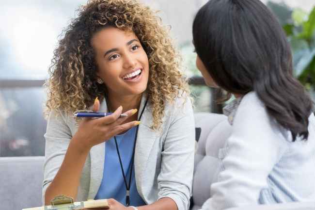 Therapist talks with young woman