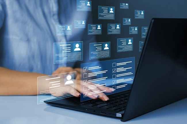 Person using laptop with floating digital profiles