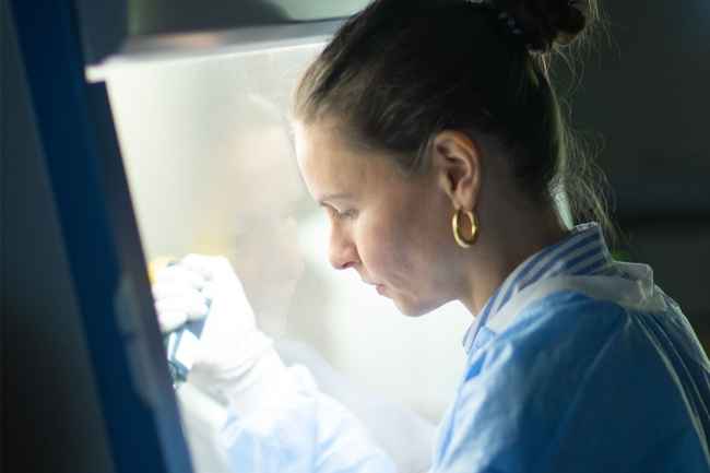 Researcher works with lab equipment