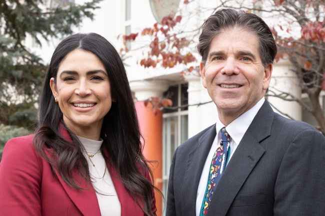 Dr. Fairlee Fabrett and Dr. Daniel Dickstein stand outside