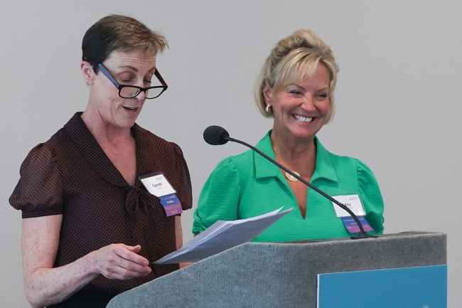 Two women at speaker podium