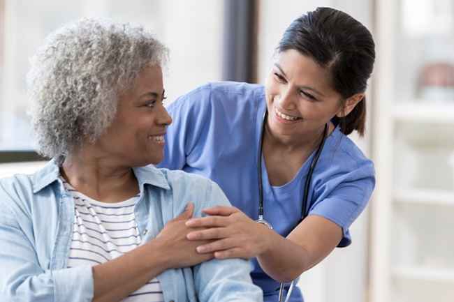 Nurse helps older patient