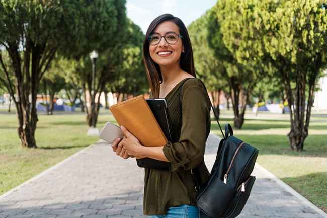 Stock image of college student with books and backpack