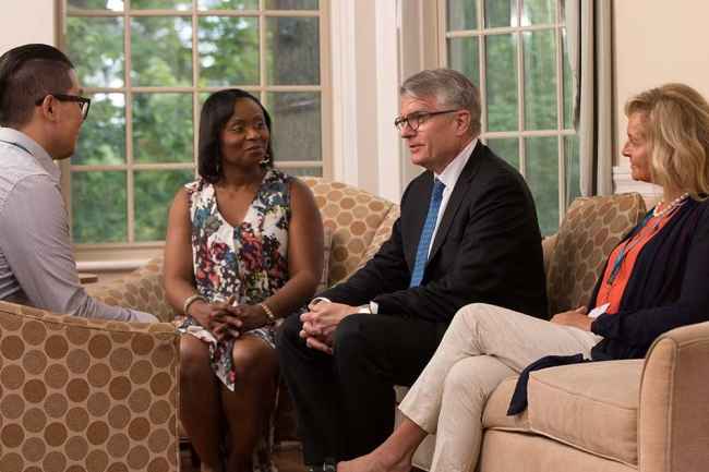 Patient and clinicians talk in living room