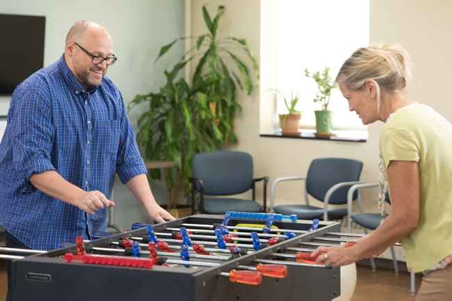 McLean staff playing foosball to find some balance in their workday