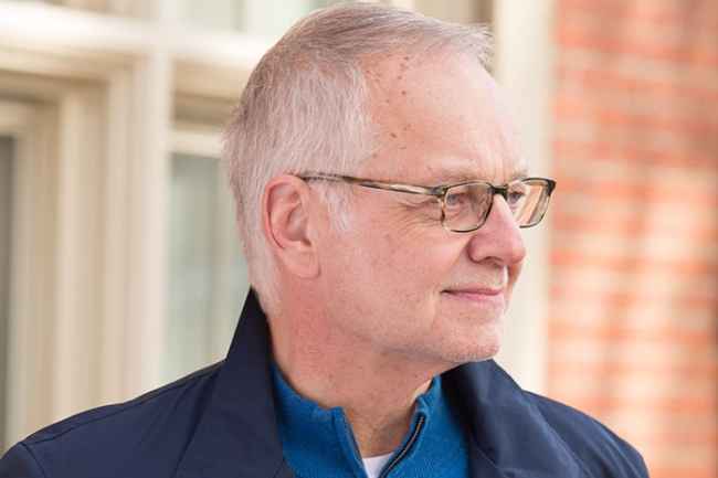 Older man outside smiling